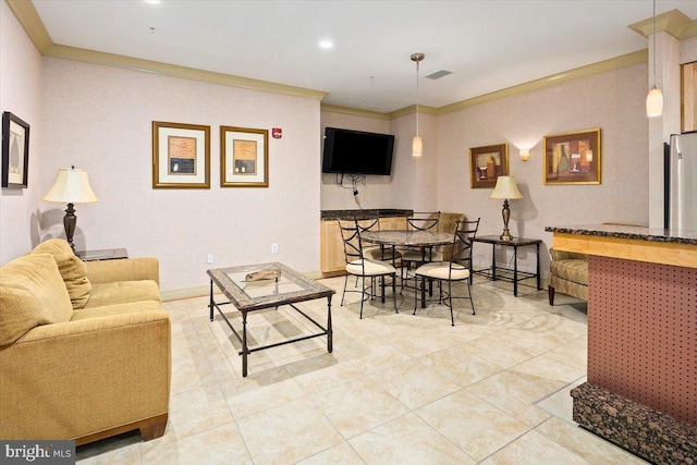 living area featuring tile patterned flooring, visible vents, and crown molding