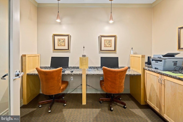 office area with dark colored carpet, crown molding, and built in study area