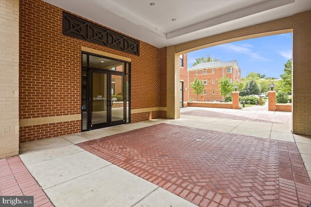 entrance to property featuring a patio area and french doors