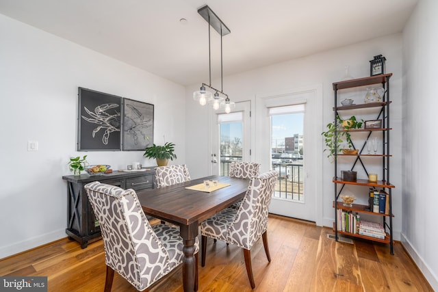 dining room with hardwood / wood-style floors and baseboards