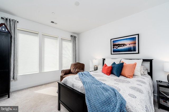 bedroom featuring light carpet, baseboards, and visible vents