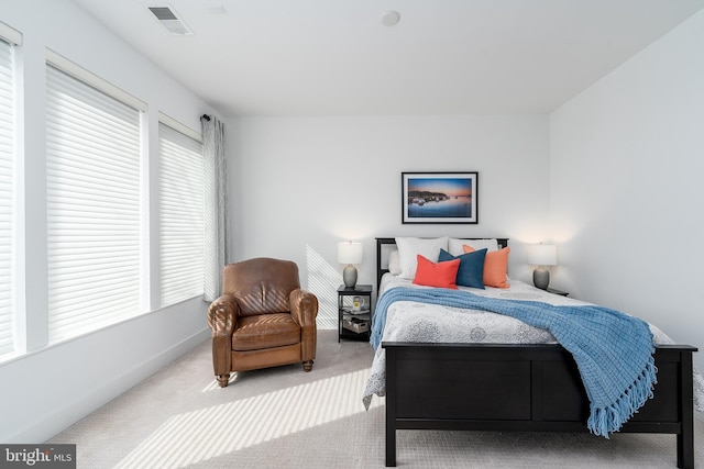 carpeted bedroom featuring visible vents and baseboards