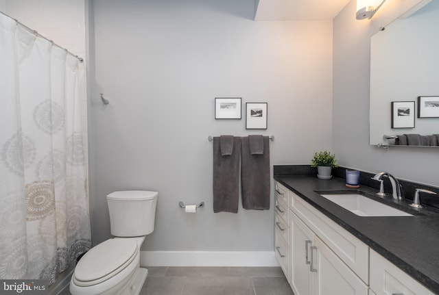 bathroom with toilet, tile patterned flooring, baseboards, and vanity