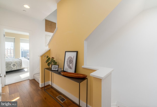 corridor featuring baseboards, visible vents, dark wood finished floors, and recessed lighting