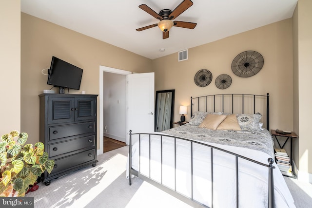 bedroom with lofted ceiling, ceiling fan, and visible vents