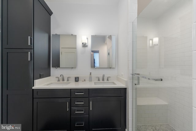 bathroom featuring double vanity, a sink, and a shower stall