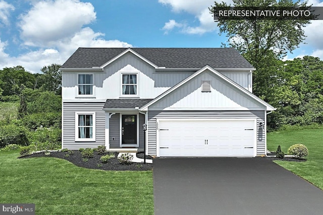 view of front facade with driveway, an attached garage, a front lawn, and a shingled roof