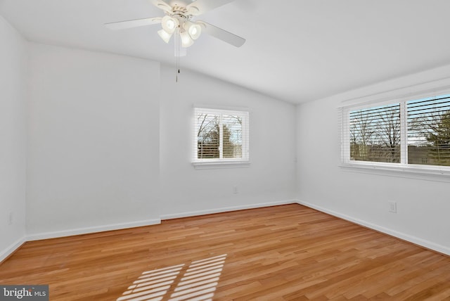 empty room featuring ceiling fan, light wood-type flooring, and lofted ceiling