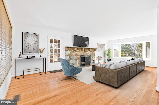 living room with a fireplace and hardwood / wood-style floors