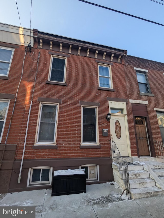 view of property with brick siding