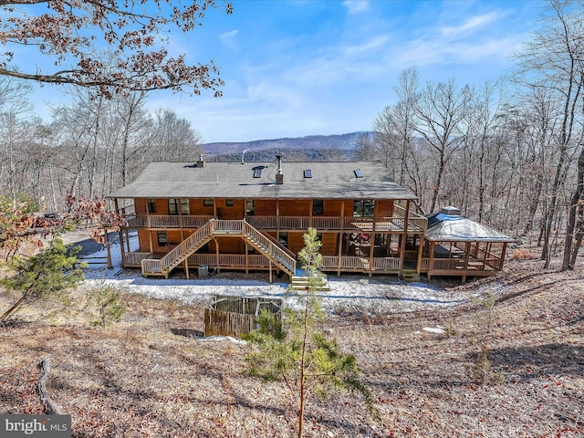 back of house featuring a deck with mountain view, stairway, and a gazebo