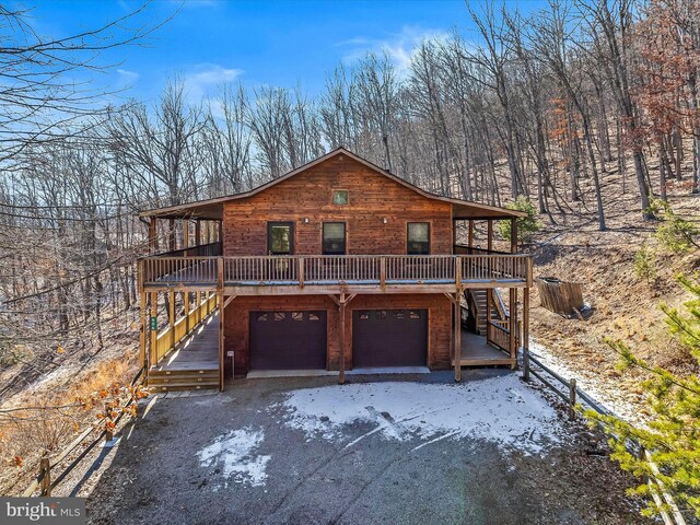 606 Rocky Branch Rd, Baker, WV 26801 - rustic home featuring stairs, an attached garage, and a wooden deck