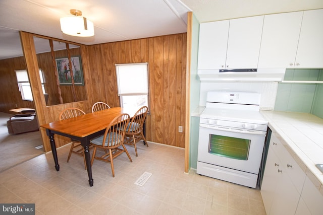 dining room featuring wooden walls