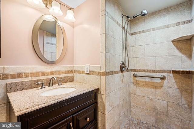 bathroom featuring vanity and tiled shower