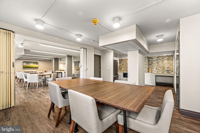 dining space with dark wood-type flooring