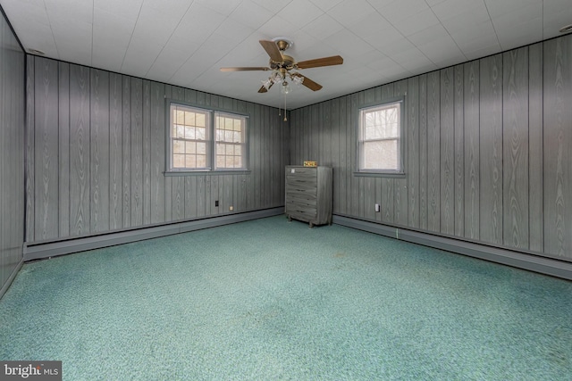 unfurnished room featuring ceiling fan and a baseboard radiator