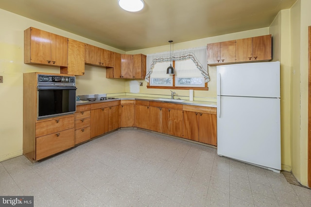 kitchen with sink, black appliances, and hanging light fixtures