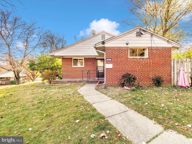 bungalow-style house with a front lawn