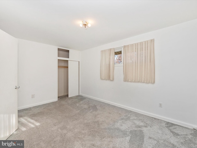 unfurnished bedroom with carpet and a closet