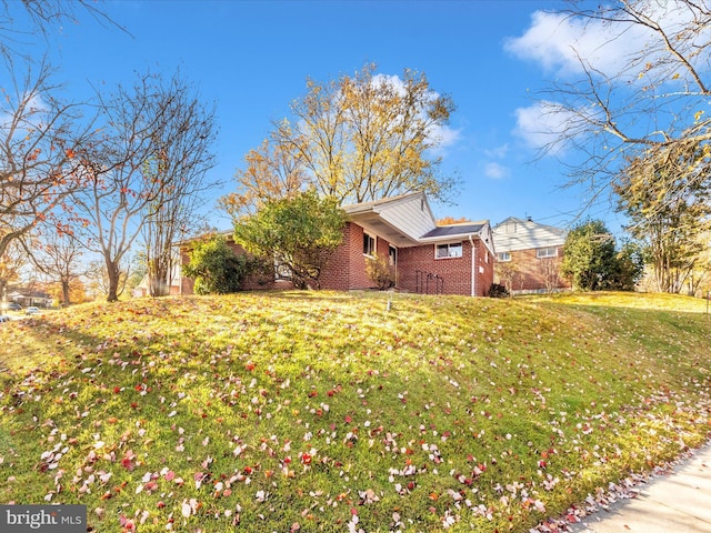 view of property exterior with a yard