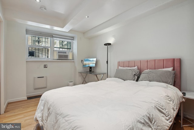 bedroom with cooling unit, recessed lighting, baseboards, and wood finished floors