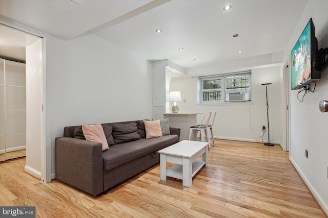 living room with light wood-type flooring, baseboards, cooling unit, and recessed lighting