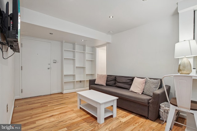 living area with light wood-style floors and recessed lighting