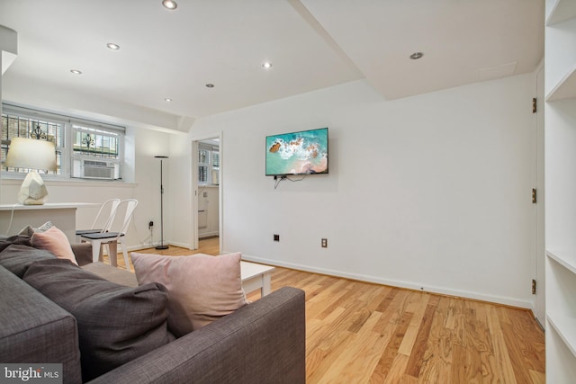 living room with light wood-style floors, baseboards, cooling unit, and recessed lighting