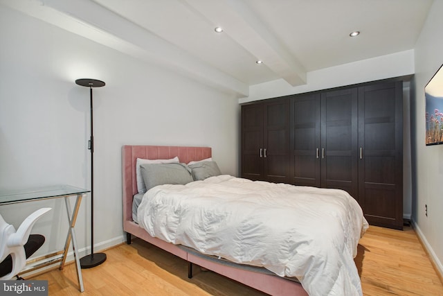 bedroom with baseboards, beamed ceiling, recessed lighting, and light wood-style floors