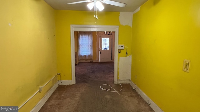 hallway featuring dark colored carpet