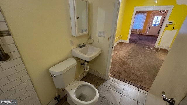 bathroom featuring sink, tile patterned flooring, and toilet