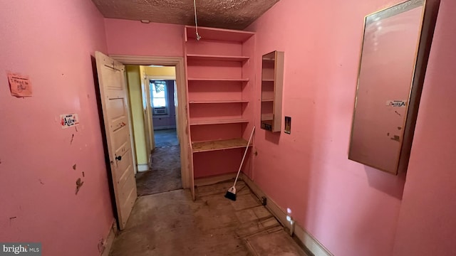 corridor with a textured ceiling