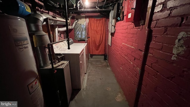 utility room with washer and dryer and water heater