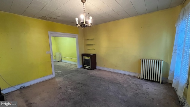 unfurnished living room featuring radiator and a notable chandelier