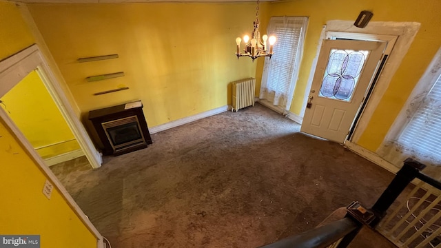 foyer with an inviting chandelier, carpet flooring, and radiator