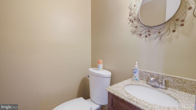 bathroom with toilet and vanity