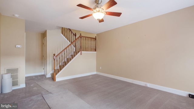 carpeted empty room featuring ceiling fan