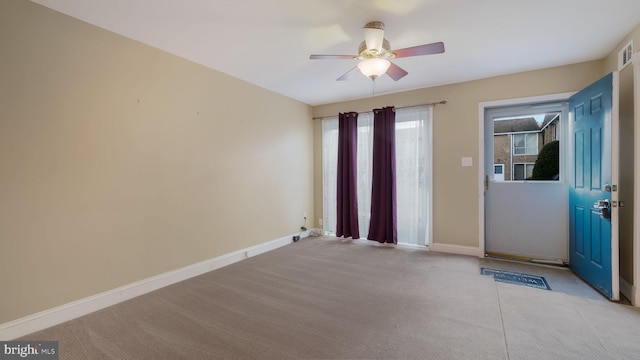 interior space with light carpet, a wealth of natural light, and ceiling fan