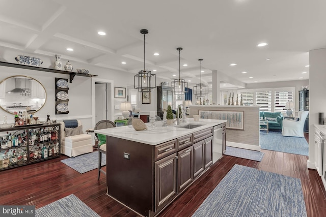 kitchen with dark wood-type flooring, open floor plan, a sink, and dishwasher