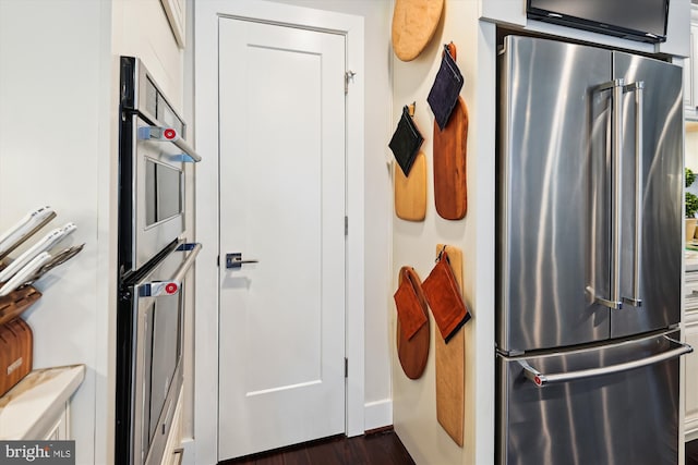 kitchen with dark wood-style floors and appliances with stainless steel finishes