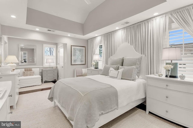 bedroom featuring lofted ceiling, visible vents, and recessed lighting