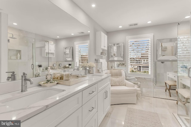 bathroom with a stall shower, a sink, visible vents, and recessed lighting