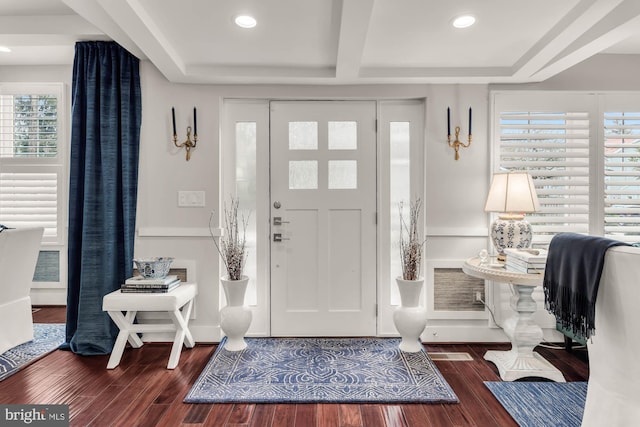 foyer entrance featuring baseboards, beamed ceiling, wood finished floors, and recessed lighting