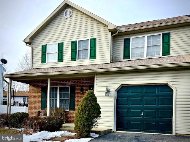 view of front of property with covered porch and a garage