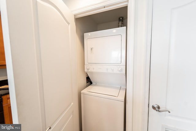 laundry area with stacked washer / dryer and laundry area