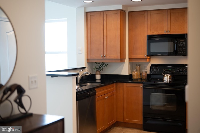 kitchen with brown cabinetry, a sink, and black appliances