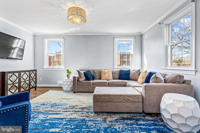 living room with ornamental molding, dark wood-type flooring, plenty of natural light, and baseboards