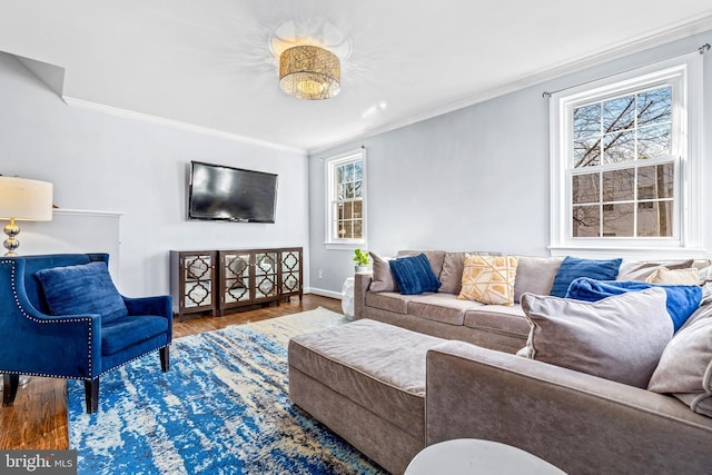 living room with crown molding, baseboards, and wood finished floors