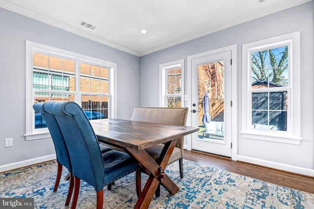 dining space featuring baseboards, visible vents, ornamental molding, wood finished floors, and recessed lighting