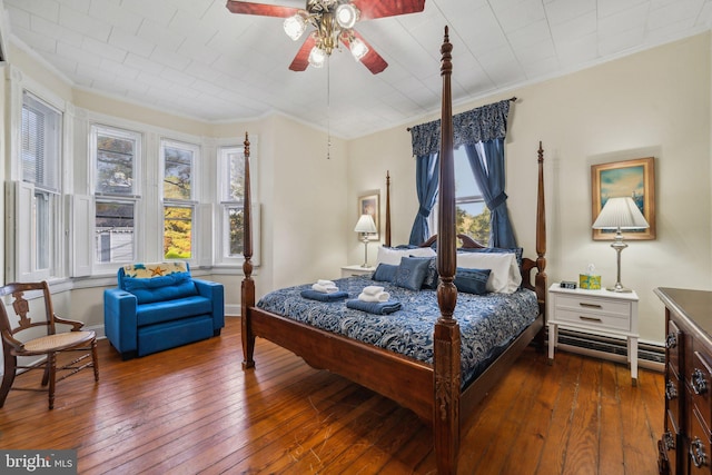 bedroom with ceiling fan, ornamental molding, dark wood-type flooring, and a baseboard radiator